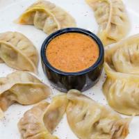 Chicken Momo · Eight pieces choice of crispy or steamed homemade nepali style steam dumplings with fresh to...