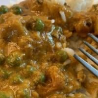 Aloo Matar · Cubes of fried potato & green peas sautéed in a flavorful Indian sauce
