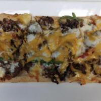 Chopped Cheesesteak Flatbread · Flatbread layered with our house-made cheese sauce, seasoned shaved ribeye, sautéed onions, ...