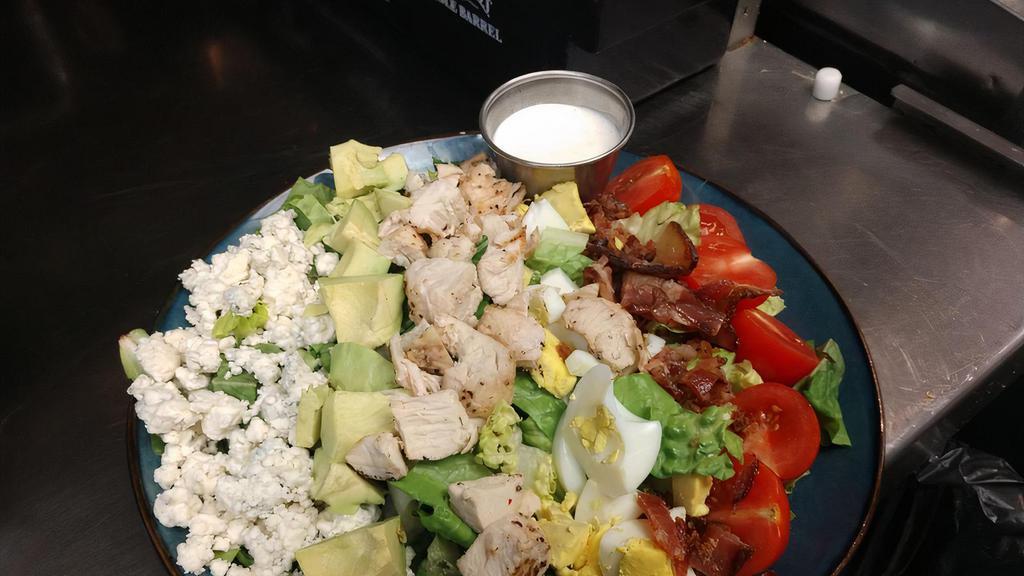 Cobb Salad · Fresh chopped romaine lettuce with chicken, tomatoes, bacon, hard boiled egg, blue cheese crumbles, avocado, and choice of dressing