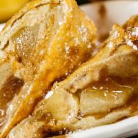 Apple Pie · Apple Pie Stuffed Egg Roll topped with powdered sugar and Carmel