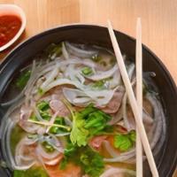 Beef Noodle Soup (Pho) · Rice noodles topped with a traditional aromatic beef broth served with a side of bean sprout...