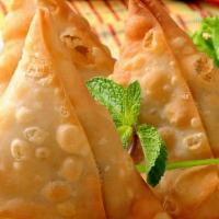 Vegetable Samosas (2) · Triangle pastries with potatoes, peas and spices.