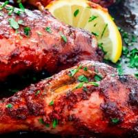 Tandoori Chicken (Full) · Marinated chicken cooked in a clay oven.