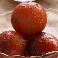 Gulab Jamun (2) · Golden balls in syrup scented with rose.
