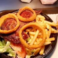 Rib-Eye Steak Plate · An 8 oz. Rib Eye Steak, served with a large salad, fries, onion rings & your choice of dress...
