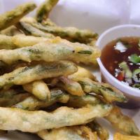Crispy Green Beans · String beans lightly battered and deep fried, served with a spicy bean sauce on the side. Ve...