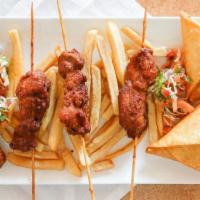 Appetizer Platter · An appetizer feast with 2 samosas, 2 sausages, 2 chicken skewers and kachumbari salad. Feeds...