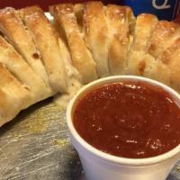 Calzone W/ One Item · Homemade dough stuffed with topping of choice, and mozzarella cheese, folded over and baked ...