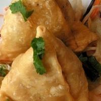 Vegetable Samosa (2 Pieces) · Potatoes and peas stuffed in a savory pastry.