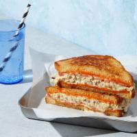 The Tuna Melt · Melted Cheddar cheese with tuna salad and tomato grilled between two slices of buttered bread.