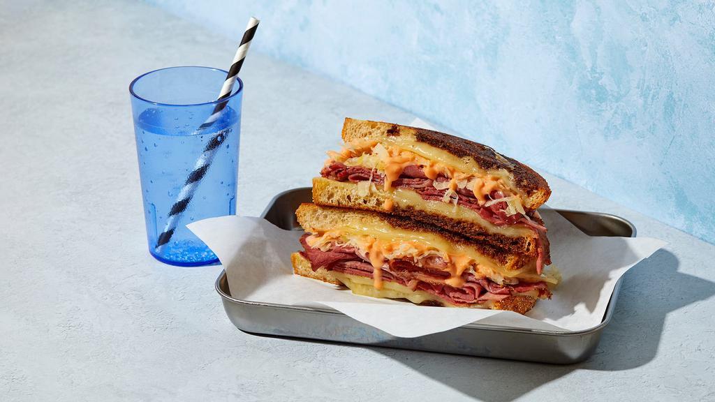 The Reuben · Melted Swiss cheese with pastrami, sauerkraut, Thousand Island dressing grilled between two slices of buttered rye bread.