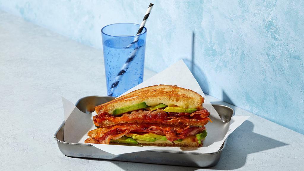 The Bacon Avocado · Melted Cheddar and Swiss cheese with bacon and avocado grilled between two slices of buttered bread.