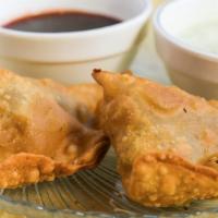 Vegetable Samosa · Triangle pastry filled with potatoes and spices.