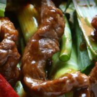 Mongolian Beef · Sliced flank steak sautéed with onion and scallions in brown sauce with blackened red chili ...