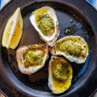 Oyster Rockefeller · Oven roasted oysters topped with spinach and bread crumbs.