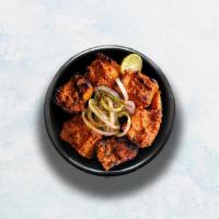 Chicken Tikka · Tender pieces of chicken marinated in yogurt, glazed in a traditional Indian clay oven.