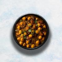 Channa Masala · Chickpeas cooked with farm-fresh vegetables and special herbs. Served with a portion of arom...