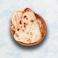 Naan · Indian white flour flatbread baked to perfection in a traditional Indian clay oven.