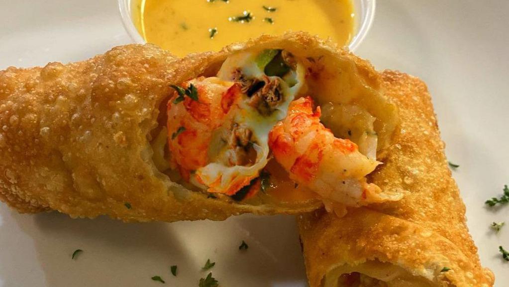 Seafood Eggrolls · Stuffed with grilled shrimp, crawfish tails, cheese and cajun rice. Served with signature dipping sauce.