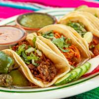 Birria Taco · Our famous birria (shredded beef) on a corn tortilla topped w onion and cilantro ,red and gr...