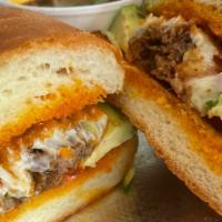 Asada Torta · Our juicy steak in our daily fresh telera bun, a layer of refried beans some shredded lettuc...