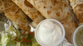 Birria Quesadilla · Loaded steak and and cheese quesadilla served w a side of sour cream and avocado slices