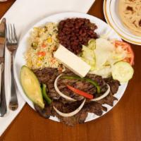 Carne Asada · Grilled beef steak served with salad, avocado, cheese, lemon rice, beans, and tortilla.