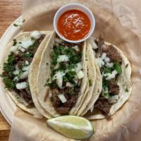 Lengua Taco · Tender, shredded beef tongue served on a corn tortilla, topped with chopped onion & cilantro...