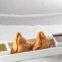 Samosa · Vegan. Delicious pastry shells filled with seasoned potato, and peas.