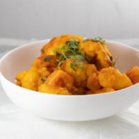 Aloo Gobi · Vegan. Cauliflower and potatoes marinated, and cooked with Indian spices. Served with basmat...
