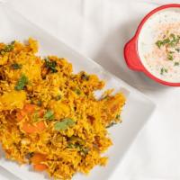 Chicken Biryani · Basmati rice cooked with chicken, and garnished with nuts.