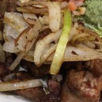Carne Asada · Slices of ribeye steak grilled with onions. Served with rice, beans guacamole salad and tort...