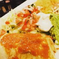 Super Chimichanga · Two flour tortillas deep fried, one chicken, one beef. Topped with cheese dip and garnished ...