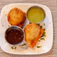 Vegetable Samosa · Two crisp turnovers filled with mild spiced potatoes and green peas.