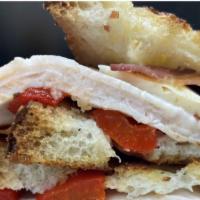 Smoked Turkey And Jack Cheese Panini · Smoked Turkey, Monterey Jack cheese, bacon, and roasted red peppers with ranch dressing.