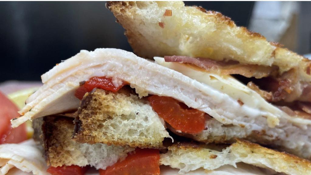 Smoked Turkey And Jack Cheese Panini · Smoked Turkey, Monterey Jack cheese, bacon, and roasted red peppers with ranch dressing.