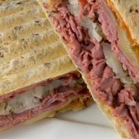 Pastrami And Provolone Panini · Sliced pastrami and provolone cheese with spicy deli mustard, tomatoes, and onions.
