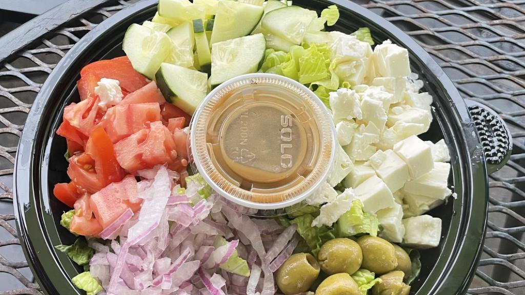 Greek Salad · Romaine lettuce, feta cheese, tomato, onion, cucumber, olives, and choice of dressing.