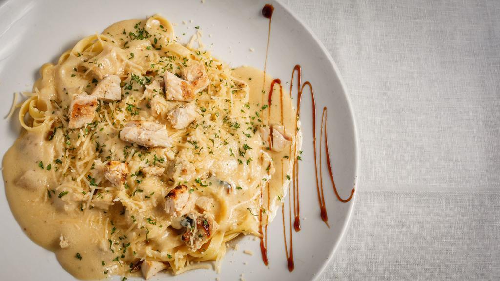 Fettuccine Alfredo · fettuccine pasta tossed with a creamy parmesan, garlic and white wine sauce
