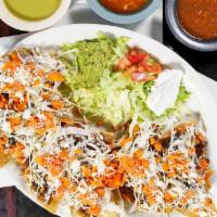Nachos De Lujo · Crispy tortilla chips with refried beans and Monterey jack cheese, decorated with cabbage, j...