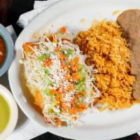 Enchiladas De La Casa · Two enchiladas seasoned with rich guajullo sauce, decorated with cabbage, jalapeños, sliced ...