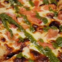 Margherita Flatbread · Topped with mozzarella, diced tomatoes and a basil pesto drizzle.