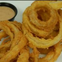 Hand-Cut Onion Rings · Thin hand cut onion rings, lightly breaded then deep fried until golden brown. Served with o...