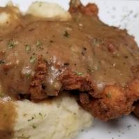 Country Fried Chicken · Buttermilk chicken breast lightly breaded and deep fried to a golden brown over garlic mashe...