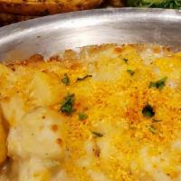 New England Baked Cod · Fresh Atlantic Cod baked in white wine, topped with our house chowda and old bay ritz cracke...