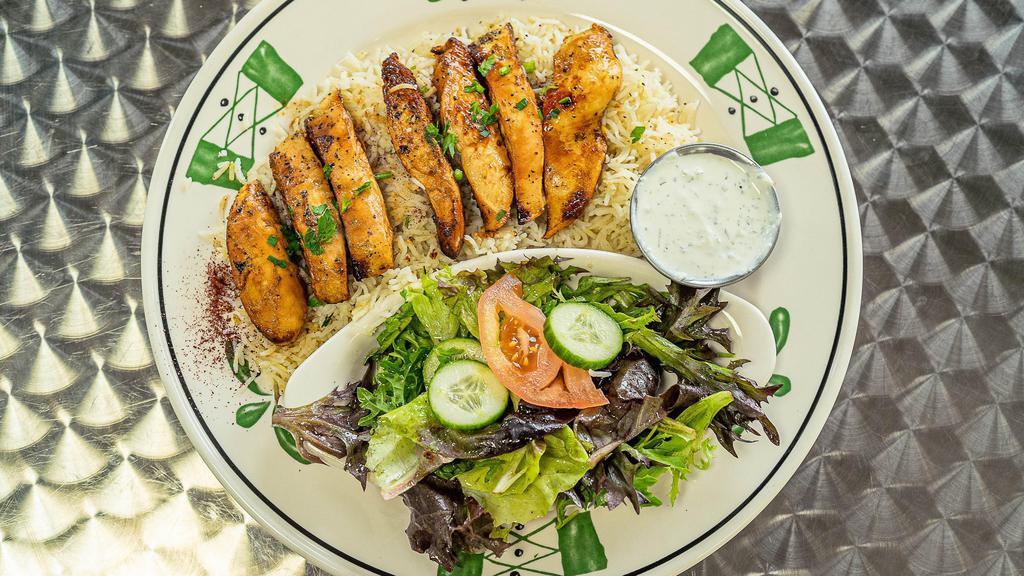 Grilled Chicken Plate · Grilled boneless Chicken breast  on bed of rice and Mediterranean salad and Tzatziki sauce