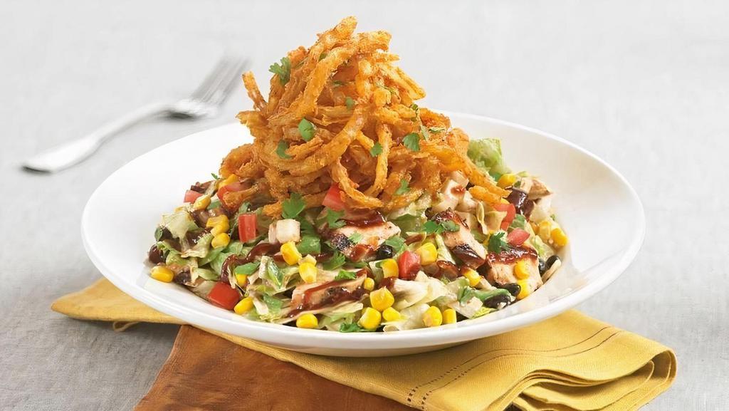 Bbq Chopped Salad · Fresh chopped romaine tossed with our special BBQ ranch dressing, black bean and corn salsa, diced avocado, tomatoes, cheddar cheese, BBQ grilled chicken and piled high with crispy onion straws.