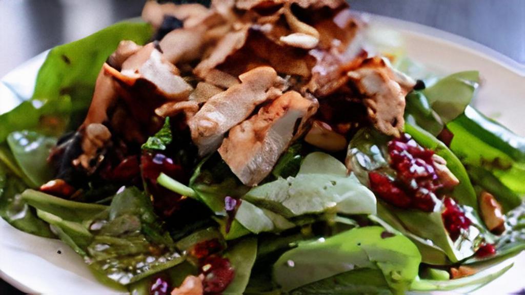 Cranberry Spinach Chicken · Spinach topped with grilled chicken breast, tomatoes, cranberries, pecans and crumbled blue cheese, served with raspberry vinaigrette