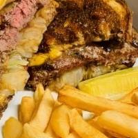 Patty Melt · Classic Melt served on grilled marble rye, topped with caramelized onions,  American and Swi...